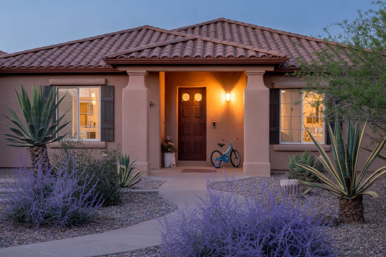 A welcoming Phoenix home at dusk with purple sage along the walk
